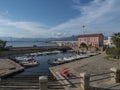 Arbatax, Sardinia, Italy, September 9, 2020: View of Arbatax harbour, port with ships, fishing boats and pink house of