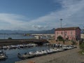 Arbatax, Sardinia, Italy, September 9, 2020: View of Arbatax harbour, port with ships, fishing boats and pink house of