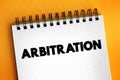 Arbitration - form of alternative dispute resolution that resolves disputes outside the judiciary courts, text concept on notepad Royalty Free Stock Photo