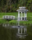 Arbor with a bridge on a pond Royalty Free Stock Photo