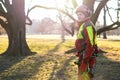 Arborist men standing against two big trees. The worker with helmet working at height on the trees. Lumberjack working with ch Royalty Free Stock Photo