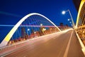 Arc bridge girder highway car light trails city night landscape Royalty Free Stock Photo