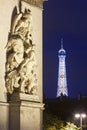 Arc de Triomphe and Eiffel tower illuminated at night in Paris