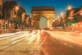 Arc De Triomphe and light trails at twilight, Paris