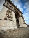 The Arc de Triomphe in Paris with Dramatic Sculptural Relief and a Bright Sky Royalty Free Stock Photo