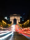 Arc de Triomphe in Paris, France at night with red car lights on the street in long exposure Royalty Free Stock Photo