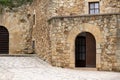 Arc entry facade door on a medieval rock stone building