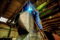 Factory worker welding a filter tank.