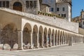 The arcades of the lower square in the historic center of Assisi, Perugia, Italy