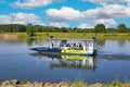 Small passenger and bicycle ferry on the river Maas in beautiful idyllic rural dutch summer landscape