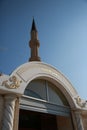 The arch above the entrance and minaret of the Huzur Camii mosque. Kemer Royalty Free Stock Photo