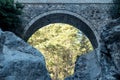 Arch of ancient Roman bridge over a mountain river in the Kesme Bogazi canyon, Turkey Royalty Free Stock Photo
