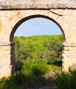 Arch of antique roman aqueduct Royalty Free Stock Photo