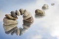 Arch of balanced pebbles and stepping stones in the water with r