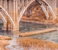 Arch bridge with spandrel columns spanning a river Royalty Free Stock Photo