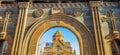 Arch and church. Stone wall with crosses. The monastery is visible through the arch. Beautiful architecture of churches