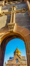 Arch and church. Stone wall with crosses. The monastery is visible through the arch. Beautiful architecture of churches