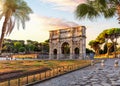 The Arch of Constantine behind the palms, famous place of visit in Rome, Italy Royalty Free Stock Photo
