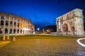 Arch of Constantine and the Colosseum illuminated at night in Rome, Italy Royalty Free Stock Photo