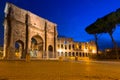 Arch of Constantine and the Colosseum illuminated at night in Rome, Italy Royalty Free Stock Photo