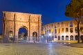 Arch of Constantine and the Colosseum illuminated at night in Rome, Italy Royalty Free Stock Photo