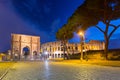 Arch of Constantine and the Colosseum illuminated at night in Rome, Italy Royalty Free Stock Photo