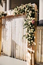 Arch decorated with flowers at the wedding caremony. White and gold color. Rose