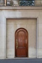 Arch door entrance of old building in Paris France. Vintage wooden doorway and marble stone wall of ancient house. Royalty Free Stock Photo