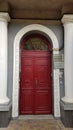Arch entrance to elegant red door of historic building in European city Odessa of Ukraine