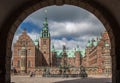 Arch framing the Neptune Fountain and the Frederiksborg castle in Hilerod, Denmark Royalty Free Stock Photo