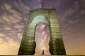 The Arch of Freedom monument Purple Milky way falling stars