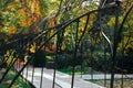 Arch in a garden, tunnel, path, walkway in a park. Green and yellow fall trees. Royalty Free Stock Photo