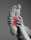 Arch pain caused by inflammation, overuse, plantar fascia injury. Woman hands holding foot with red point. Black and