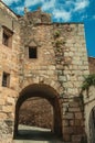 Arch passage underneath old stone building at Caceres