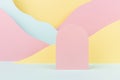 Arch pink podium mockup with abstract mountain landscape - colorful pastel pink, yellow, mint color slopes in baby cartoon naive.