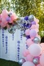 Arch of pink and purple balloons for girl happy birthday party. Outdoors summer event. Festive decorative elements, photo zone. Royalty Free Stock Photo