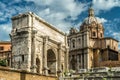 Arch of Septimius Severus and old church on Roman Forum in summer, Rome, Italy Royalty Free Stock Photo