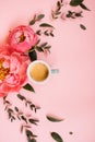 Arch shape of delicious fresh morning espresso coffee, eucalyptus leaves and blossoming coral peonies on the tender pink backgroun