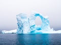 Arch shaped iceberg in Pleneau Bay iceberg graveyard west of Ant