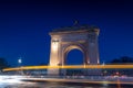 Arch of Triumph Arcul de Triumf building in Bucharest Romania during the evening with traffic lights at bottom of it Royalty Free Stock Photo