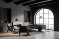 Arch window in modern grey living room. Corner view