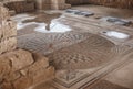 Archaeological dig during rain. Mosaic floor with puddles