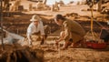 Archaeological Digging Site: Two Great Archeologists Work on Excavation Site, Carefully Cleaning
