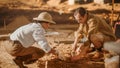 Archaeological Digging Site: Two Great Archeologists Work on Excavation Site, Cleaning Cultural