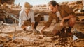 Archaeological Digging Site: Two Great Paleontologists Cleaning Newly Discovered of Dinosaur Royalty Free Stock Photo
