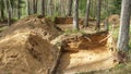 Archaeological excavation in a forest. A large plundering pit dug by archaeologist at an archaeological site