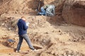 Archaeological excavations. The archaeologists in a digger process, researching the tomb with human bones, drawing the human remai