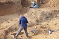 Archaeological excavations. The archaeologists in a digger process, researching the tomb with human bones, drawing the human remai Royalty Free Stock Photo