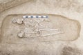 Archaeological excavations man and finds bones of a skeleton in a human burial, working tool, ruler, a detail of ancient resear Royalty Free Stock Photo