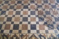 Archaeological remains of floor painted with colored square figures and above restored remains of Roman mosaic with geometric Royalty Free Stock Photo